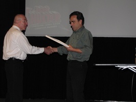 Richard Comely accepting the Hall of Fame induction from Ron Kasman