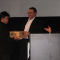 Kevin Boyd gives prize box of books to an audience member.JPG